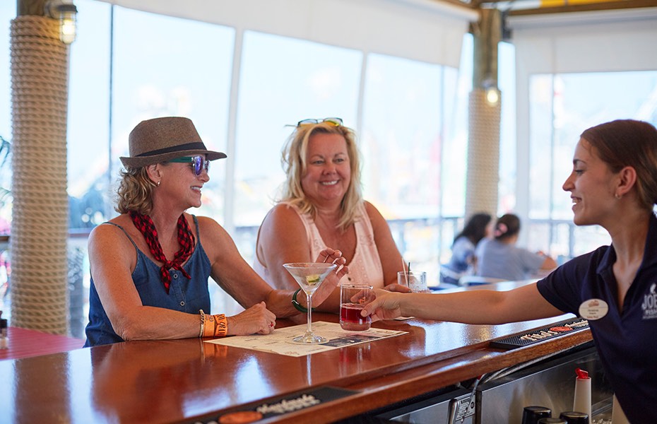 Two women at a bar.