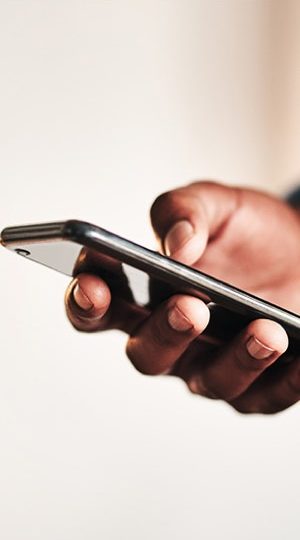 A hand holding a smartphone.