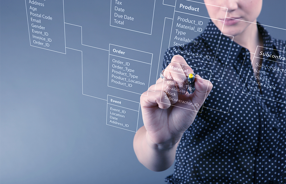 A woman working at a transparent whiteboard.