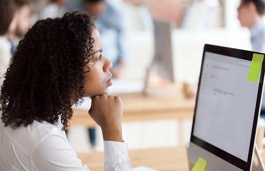 A woman working at a computer.