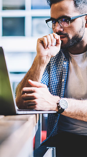 A man working at a laptop.