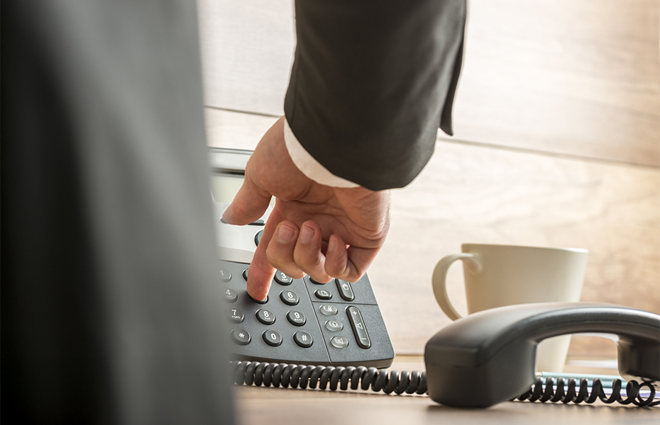 A man pushing a button on a phone.