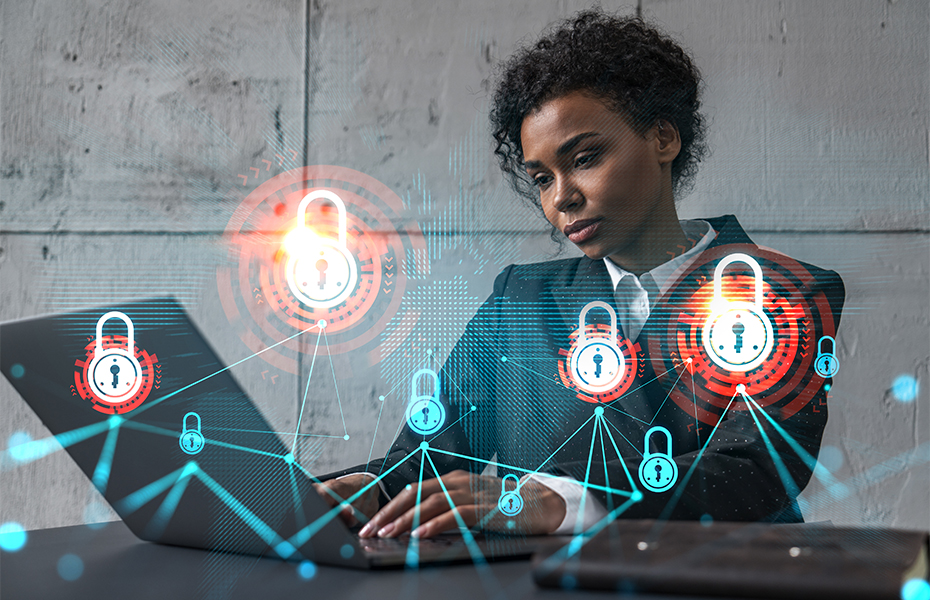 A woman working at a laptop, tying to test a network's defences.