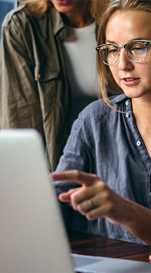 A young professional working at a laptop.