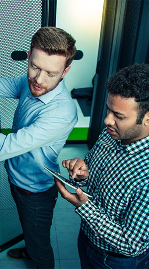 Two men working in a server room.