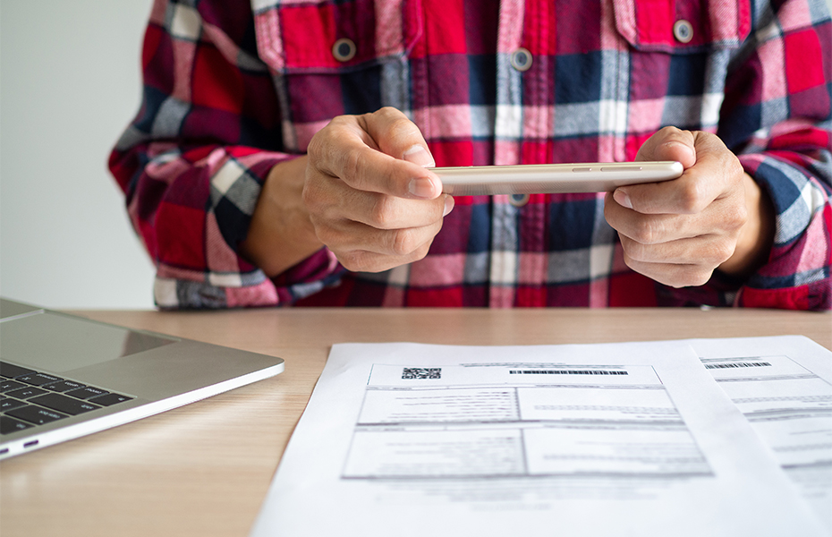 Man going over financial information on a tablet.