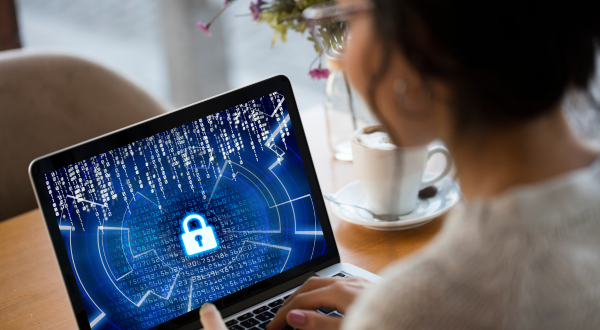 Woman at laptop with lock on her screen.