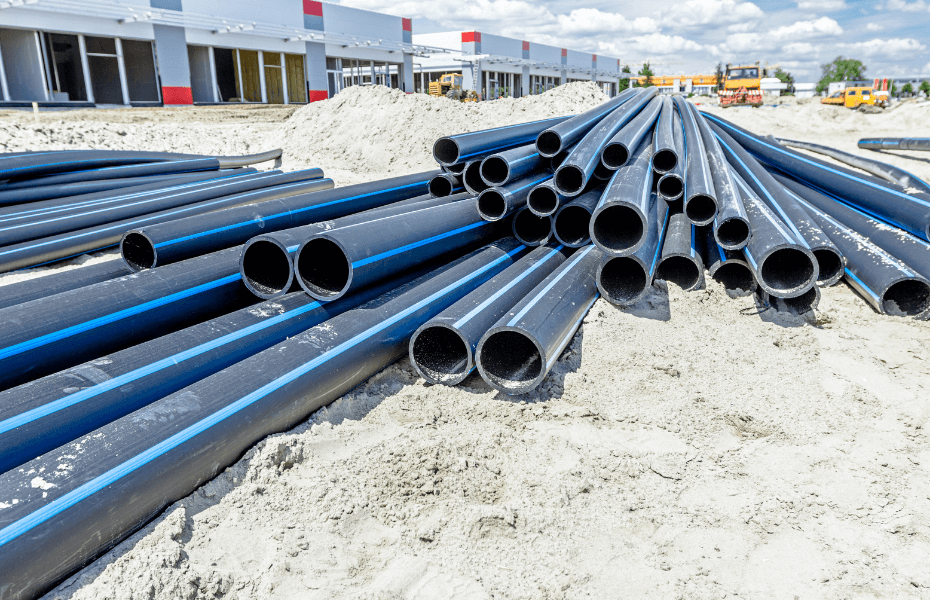 Pile of plastic pipes at a building site