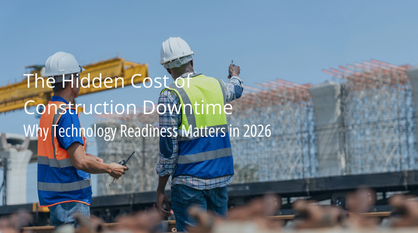 Two construction workers in hard hats and safety vests review information on a tablet at an active construction site with steel framework visible in the background. Text overlay reads: The Hidden Cost of Construction Downtime - Why Technology Readiness Matters in 2026